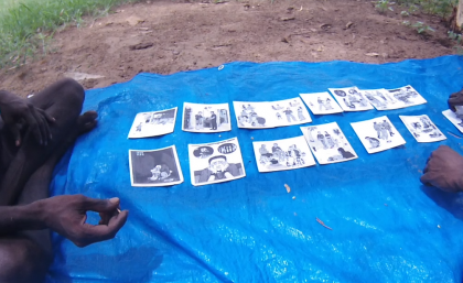 Two young men in Minyerri (faces not shown) participating in a UQ research project (looking at dialectal variation in Kriol)